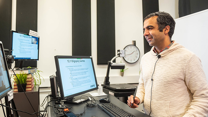 Instructor in front of a computer recording a lecture